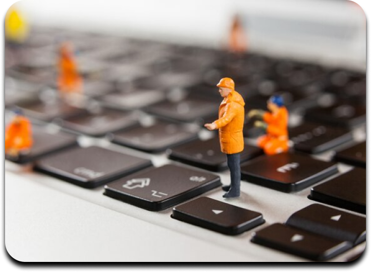 image of a construction worker figurine standing on a laptop keyboard