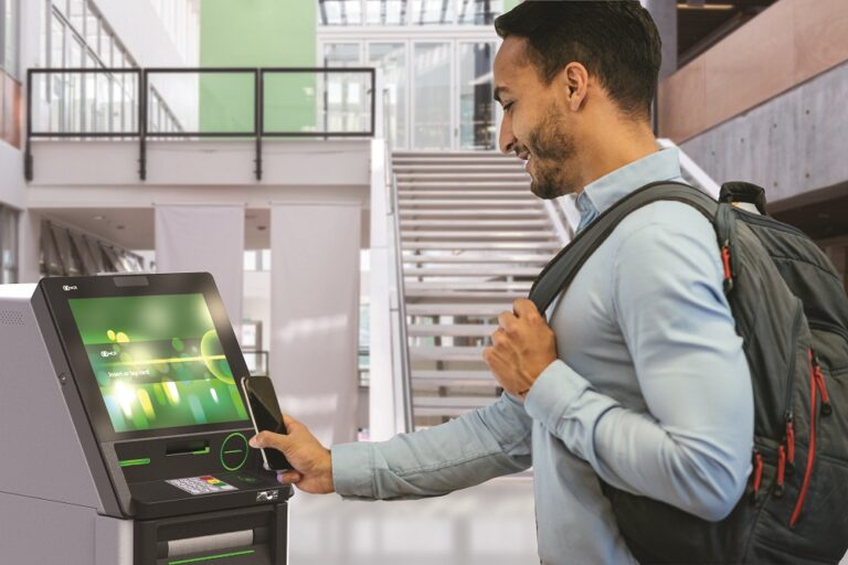 A Gen-Z consumer carries a backpack on one shoulder while using the ATM