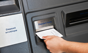 Deposit being made into an ATM
